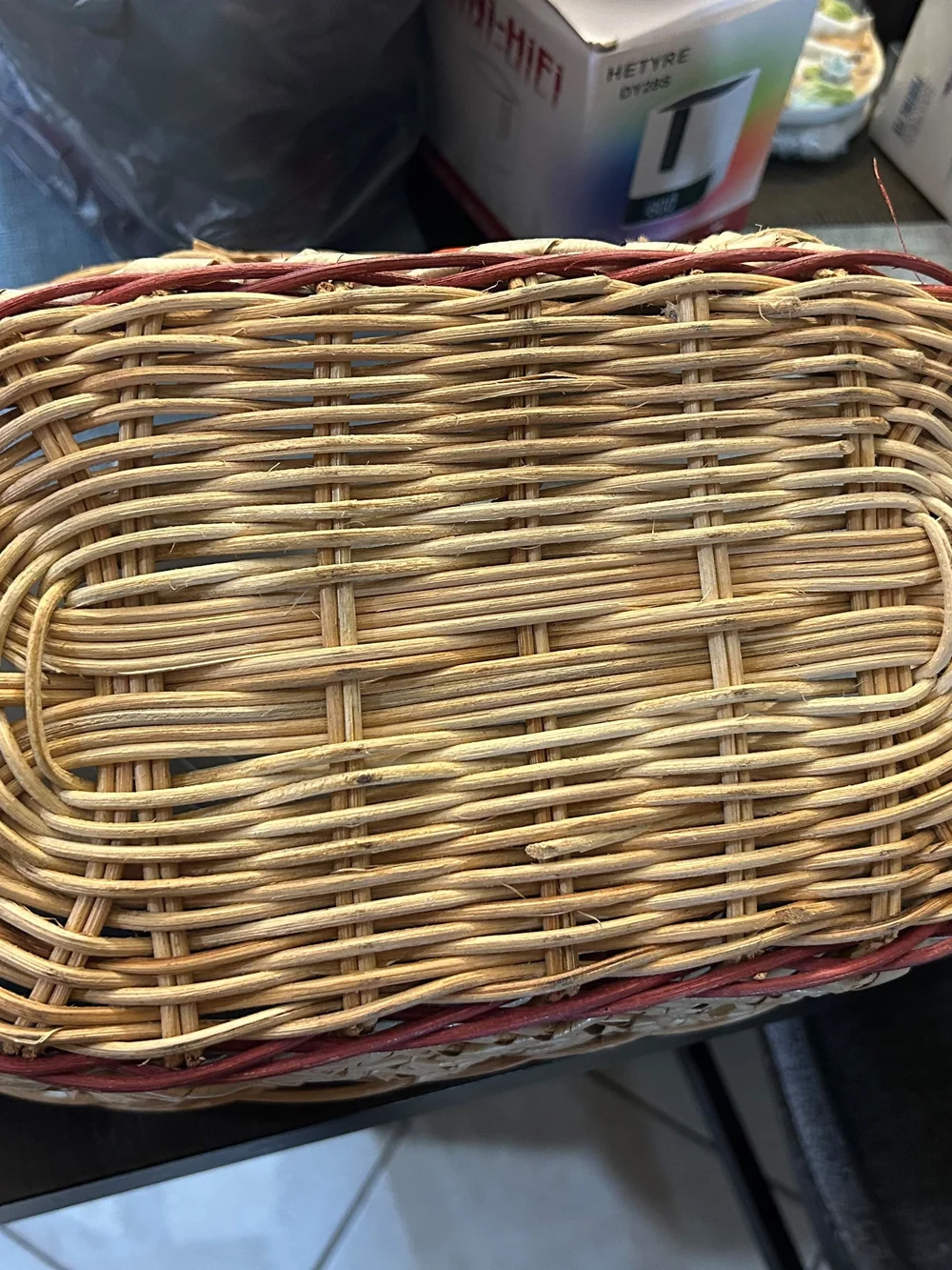 vintage woven wicker basket features hand-painted ceramic fruit tiles.